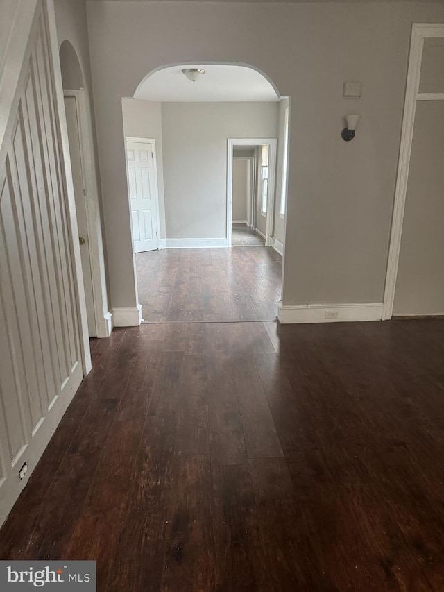 hallway with dark hardwood / wood-style flooring