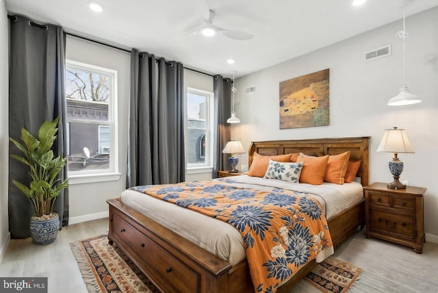 bedroom with ceiling fan and light hardwood / wood-style floors