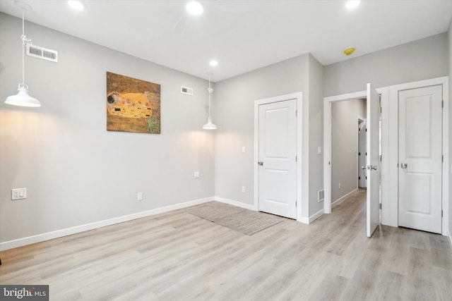 empty room with light hardwood / wood-style floors