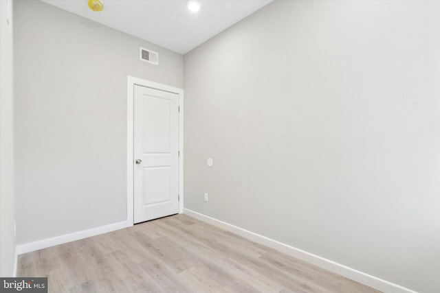 empty room with light hardwood / wood-style flooring