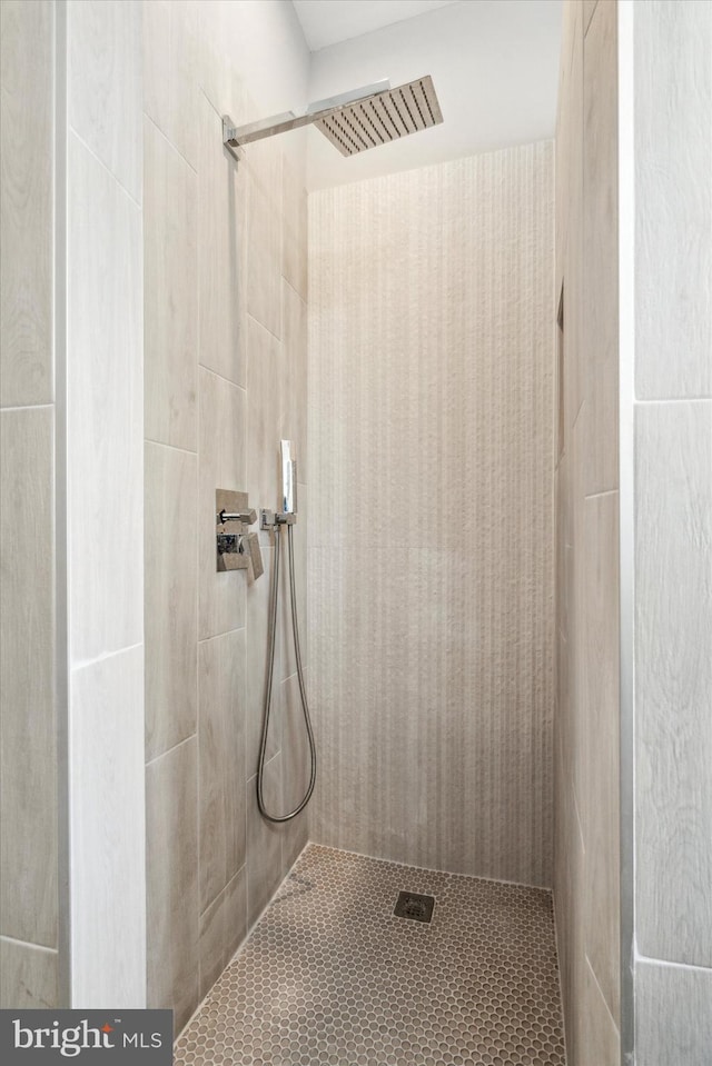 bathroom with tiled shower