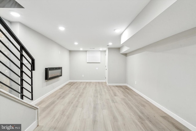 basement featuring heating unit and light wood-type flooring