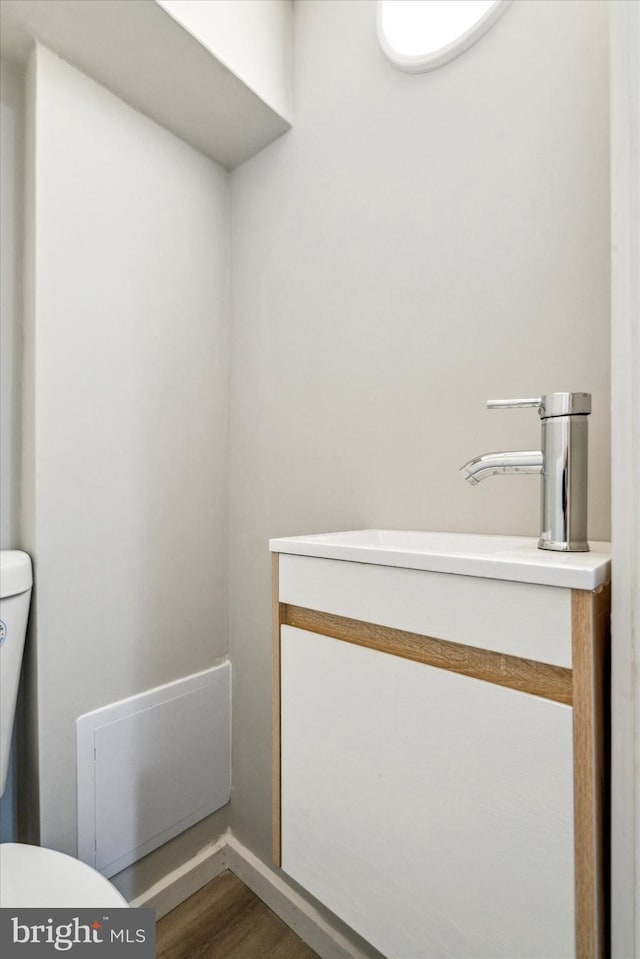 bathroom with toilet and hardwood / wood-style floors