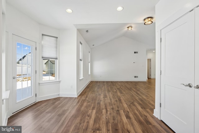 foyer entrance featuring vaulted ceiling and dark hardwood / wood-style floors