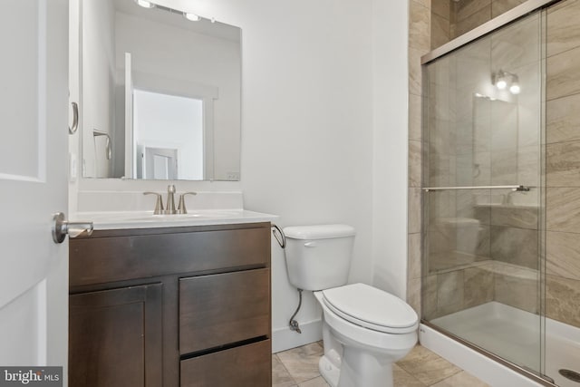 bathroom with vanity, toilet, an enclosed shower, and tile patterned flooring