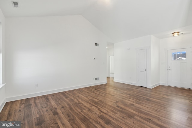 empty room featuring lofted ceiling and dark wood-type flooring