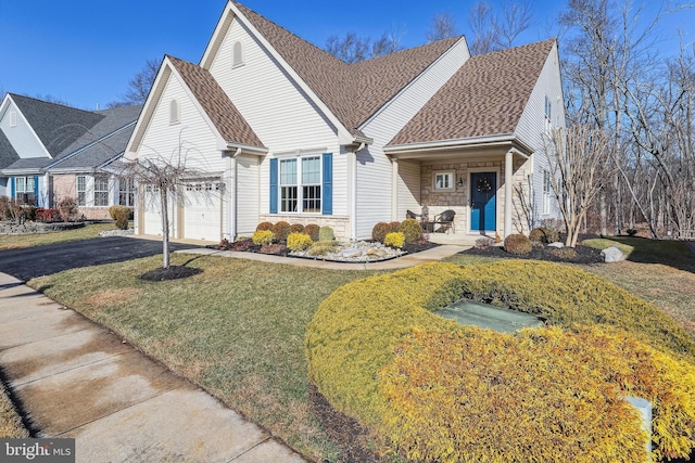 view of front of house with a garage and a front lawn