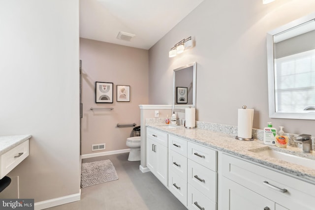 bathroom featuring vanity and toilet