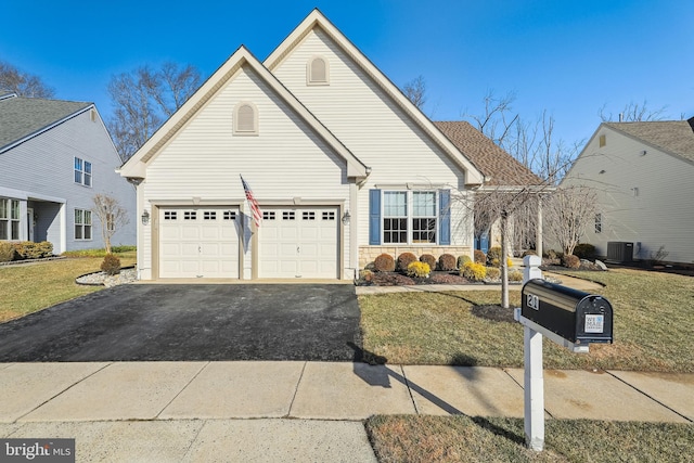 view of front of property with a front yard and central AC unit