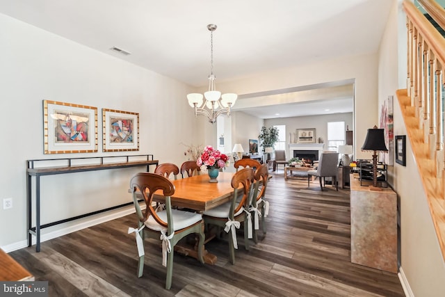 dining room featuring dark hardwood / wood-style floors and a chandelier