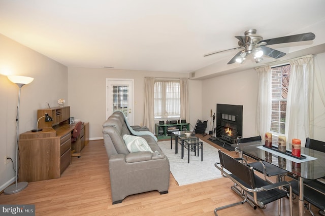 living room featuring ceiling fan and light hardwood / wood-style floors