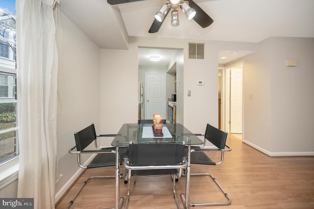 dining room with ceiling fan and light hardwood / wood-style flooring