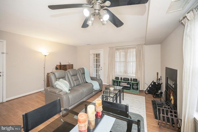 living room with ceiling fan and wood-type flooring