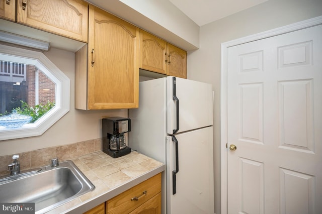 kitchen featuring white fridge and sink