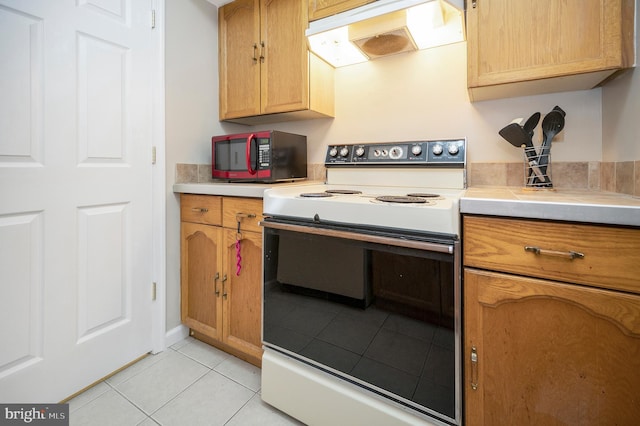 kitchen with light tile patterned floors and electric range