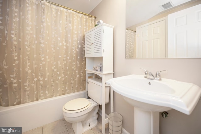 full bathroom featuring sink, tile patterned floors, toilet, and shower / bath combo with shower curtain