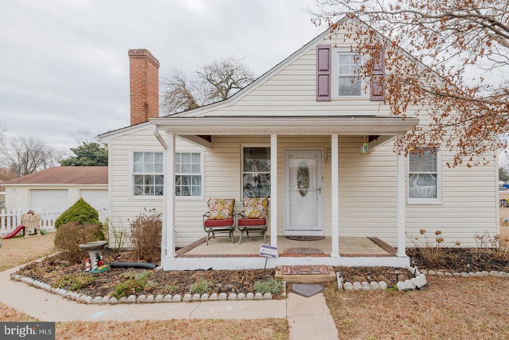 view of front of property with a porch and a garage