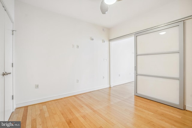 unfurnished bedroom with hardwood / wood-style flooring and ceiling fan