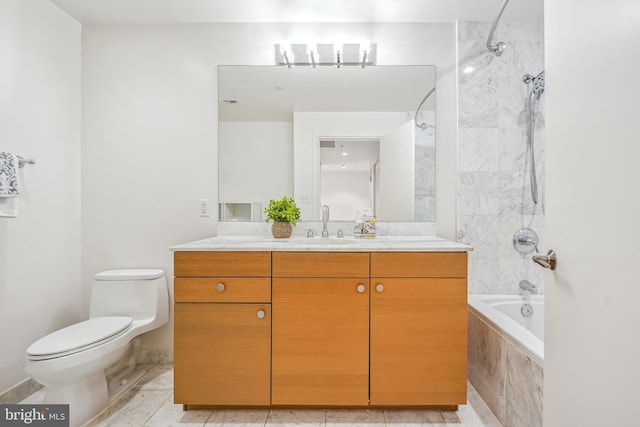 full bathroom featuring tiled shower / bath, vanity, and toilet