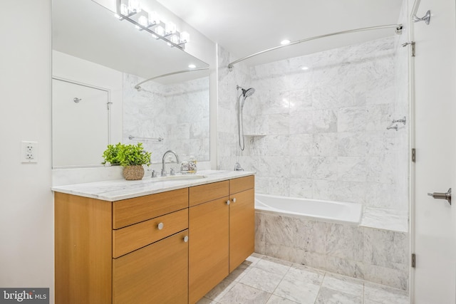 bathroom featuring tiled shower / bath combo and vanity