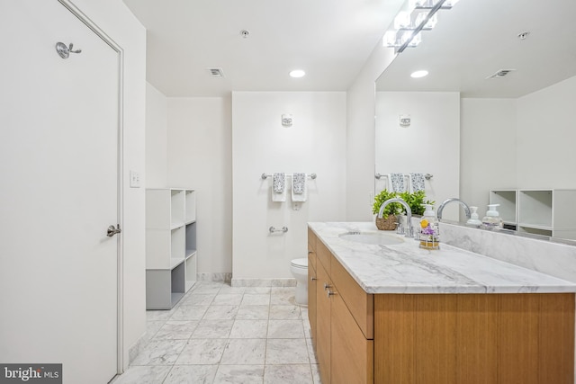 bathroom featuring vanity and toilet