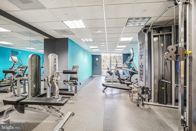 exercise room with a paneled ceiling