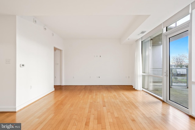 spare room with light hardwood / wood-style flooring