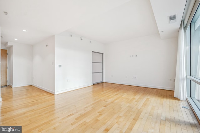 spare room with light hardwood / wood-style floors