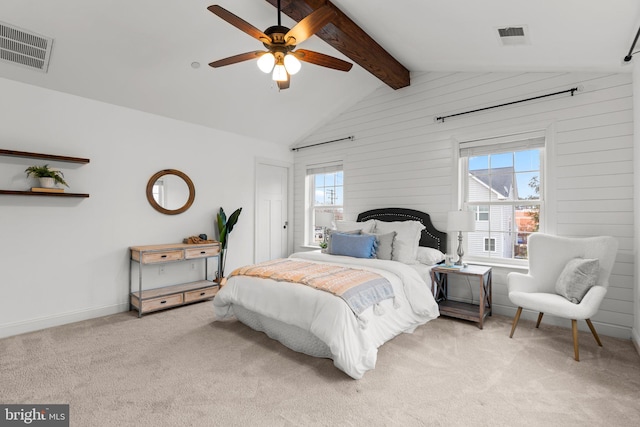 carpeted bedroom with ceiling fan and vaulted ceiling with beams