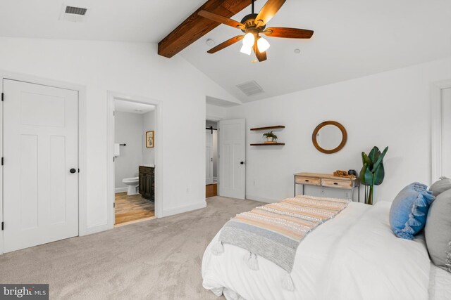 carpeted bedroom featuring ceiling fan, connected bathroom, and vaulted ceiling with beams