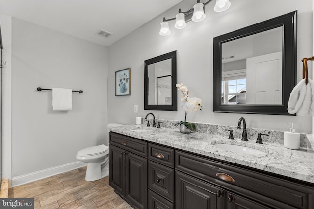 bathroom with vanity, hardwood / wood-style flooring, and toilet