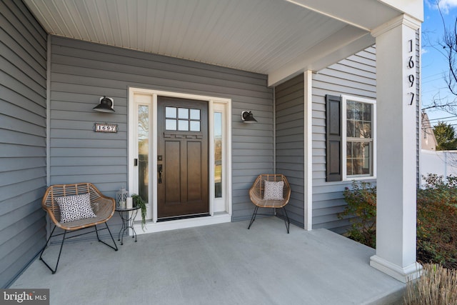 view of exterior entry featuring a porch