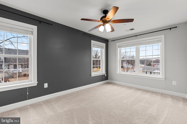 unfurnished room featuring light carpet and ceiling fan