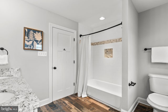 full bathroom featuring shower / bath combo, hardwood / wood-style floors, vanity, and toilet