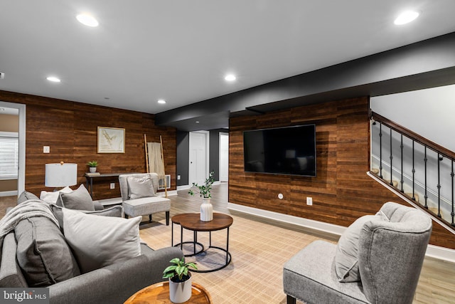 living room with wooden walls and light wood-type flooring