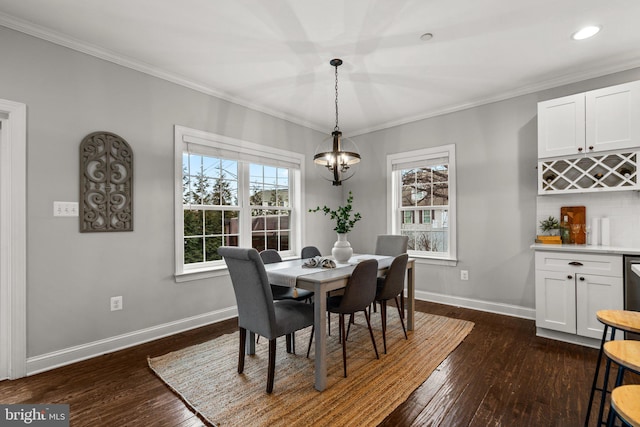 dining space with dark wood-type flooring, plenty of natural light, and ornamental molding