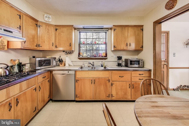 kitchen with sink, stainless steel appliances, and light tile patterned flooring