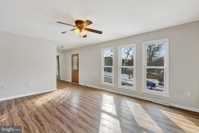 empty room with ceiling fan and light wood-type flooring