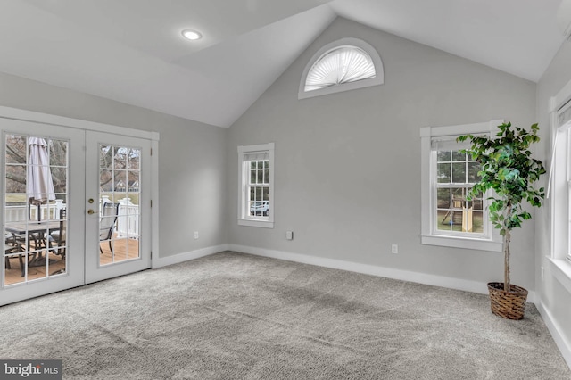 unfurnished room with french doors, high vaulted ceiling, and carpet floors