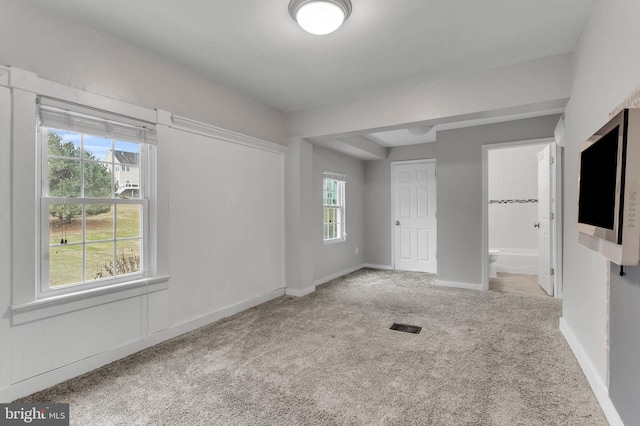 unfurnished room featuring light carpet