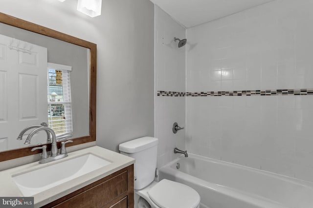 full bathroom with vanity, toilet, and tiled shower / bath combo