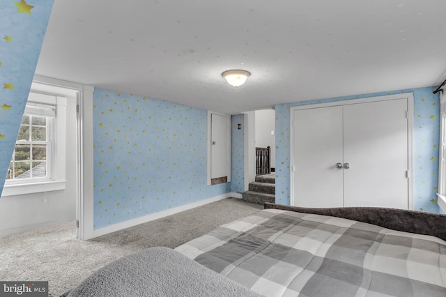 unfurnished bedroom featuring carpet flooring and a closet