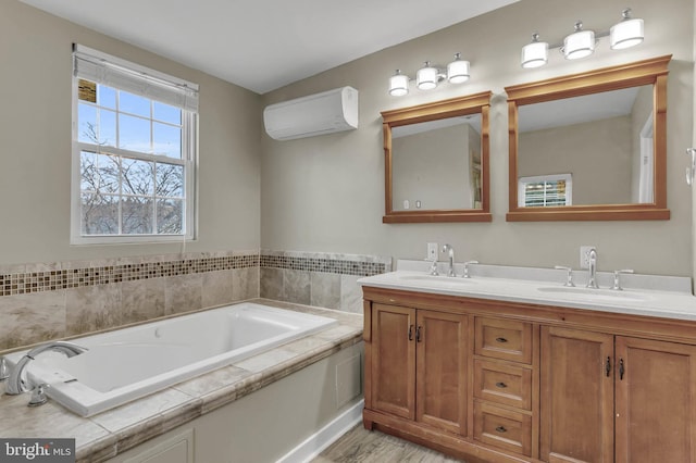 bathroom with a wall mounted air conditioner, tiled bath, and vanity