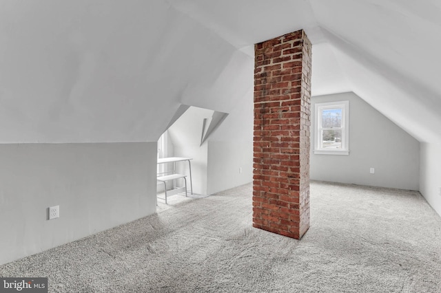 bonus room with lofted ceiling and light carpet