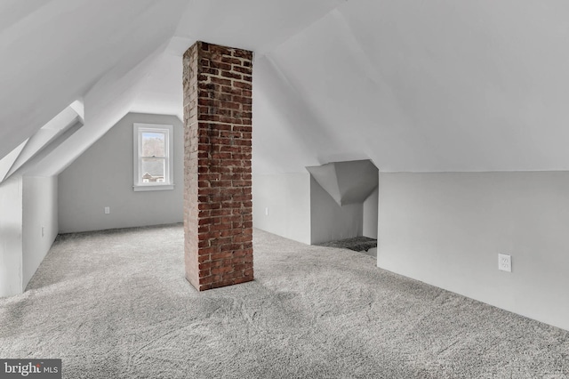 bonus room with light colored carpet and lofted ceiling