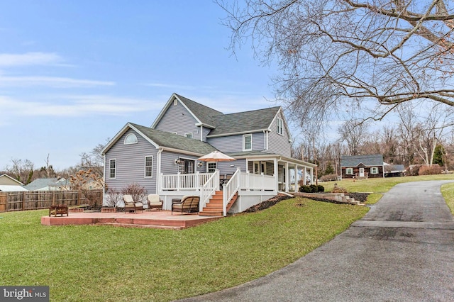 view of home's exterior with a wooden deck and a yard