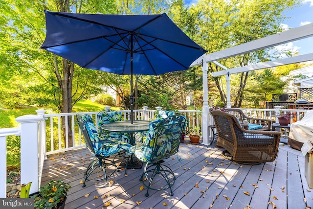 wooden terrace with outdoor dining area