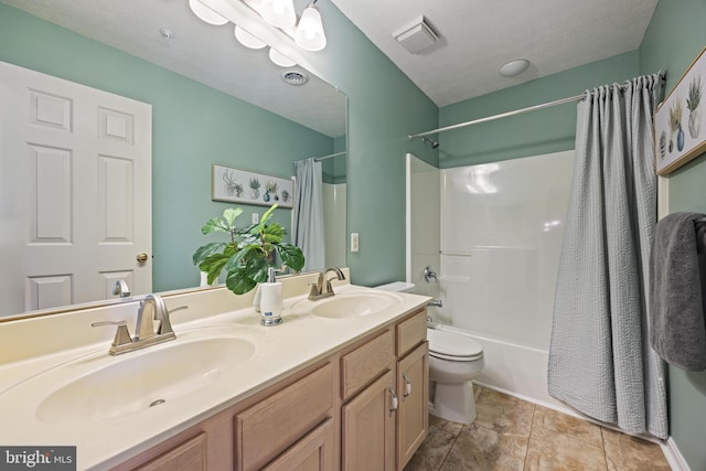 full bathroom featuring a sink, shower / tub combo with curtain, double vanity, and toilet