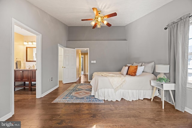 bedroom featuring ceiling fan, baseboards, wood finished floors, and ensuite bathroom