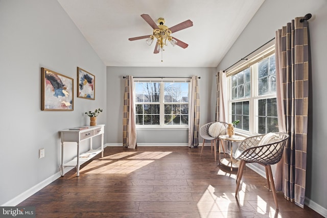 sitting room with baseboards, lofted ceiling, and wood-type flooring